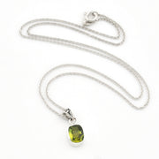 A silver chain necklace with a rectangular green gemstone pendant, displayed on a clean white background.