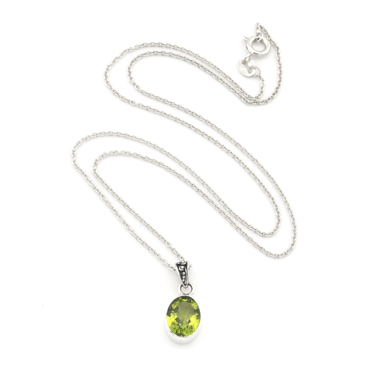 A silver chain necklace with an oval peridot pendant, displayed on a clean white background.