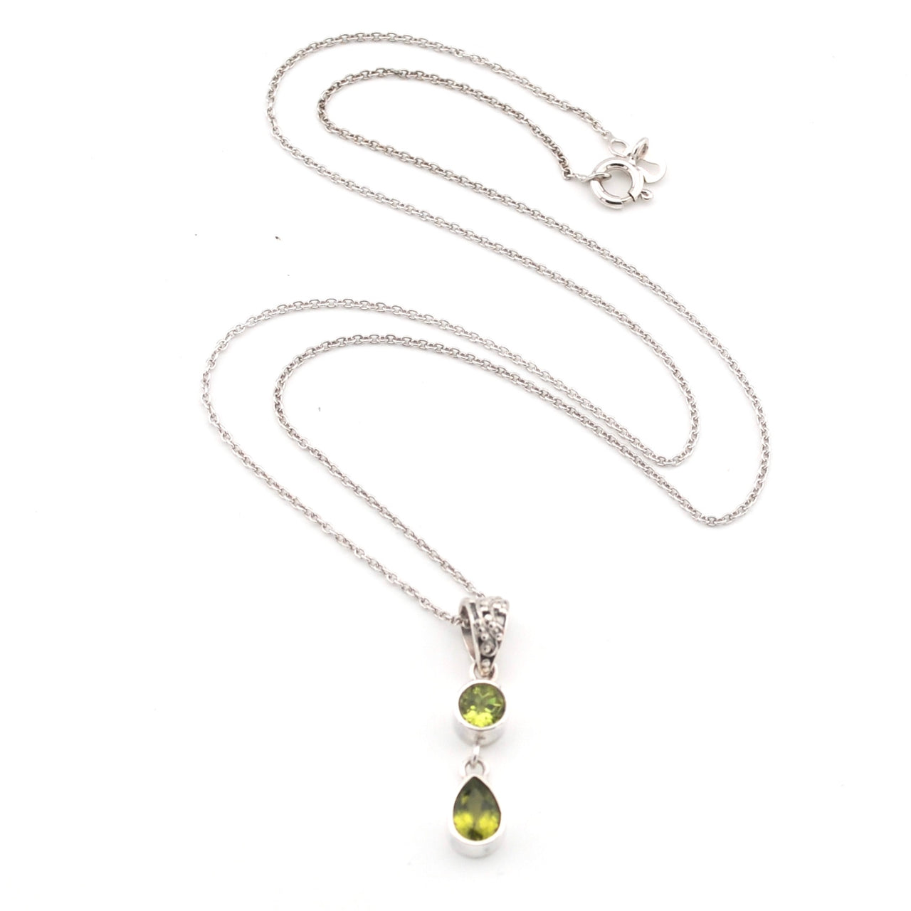 Silver necklace with a 2 green peridot stone pendant on a white background