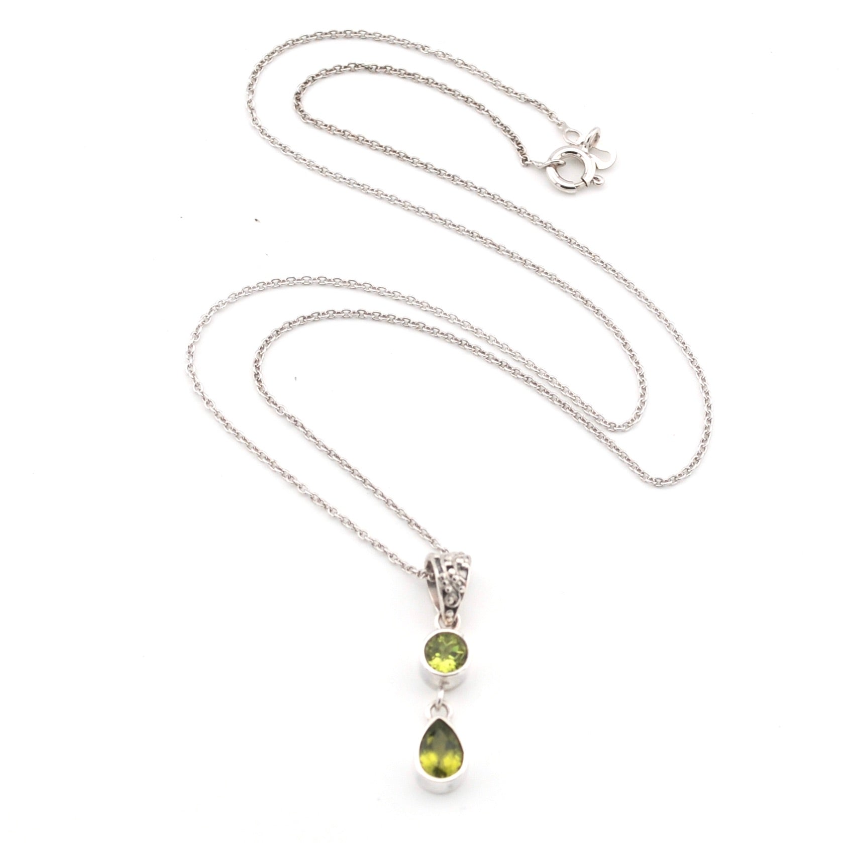 Silver necklace with a 2 green peridot stone pendant on a white background