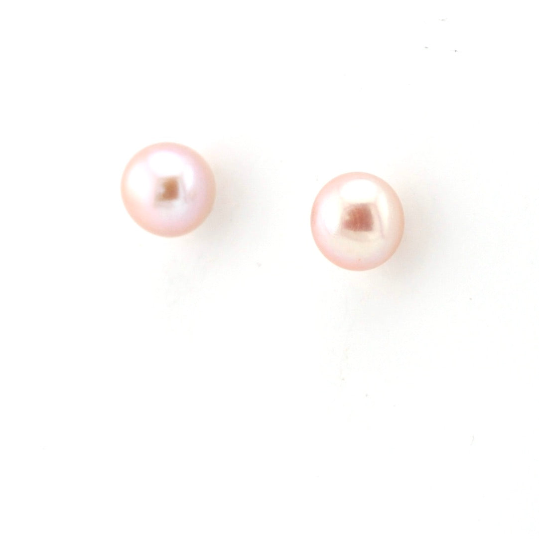 Pair of pink pearl earrings on a white background