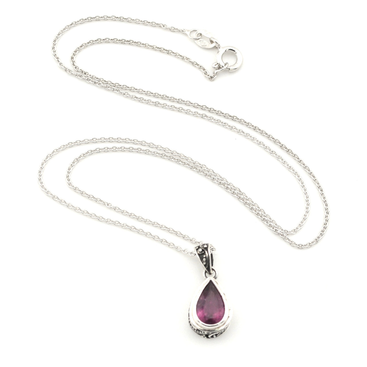 A silver teardrop pendant necklace featuring a faceted purple gemstone, displayed on a clean white background.