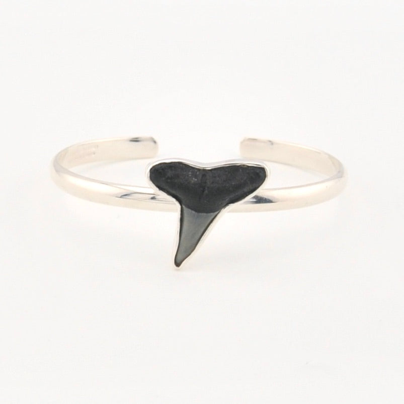 Cuff bracelet with a shark tooth on a white background