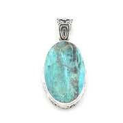 An oval pendant featuring a turquoise-blue marbled stone in a silver-toned metal bezel with a decorative bail, shown on a plain white background.