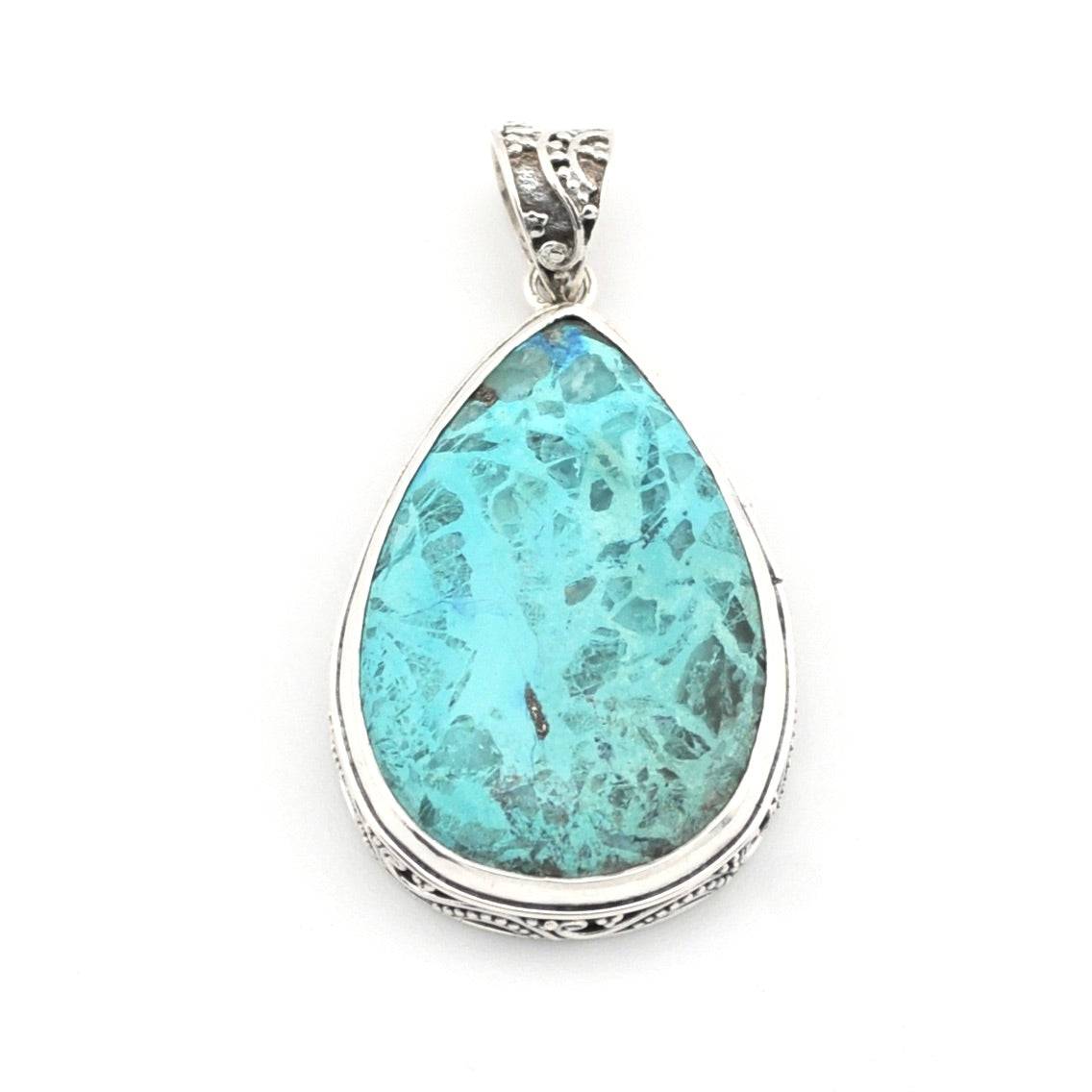 A teardrop-shaped turquoise pendant with a silver filigree border and bail, shown on a plain white background.