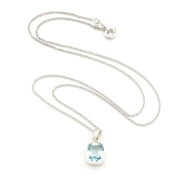 A silver chain necklace with a silver bezel-set oval light blue gemstone pendant, displayed on a clean white background.