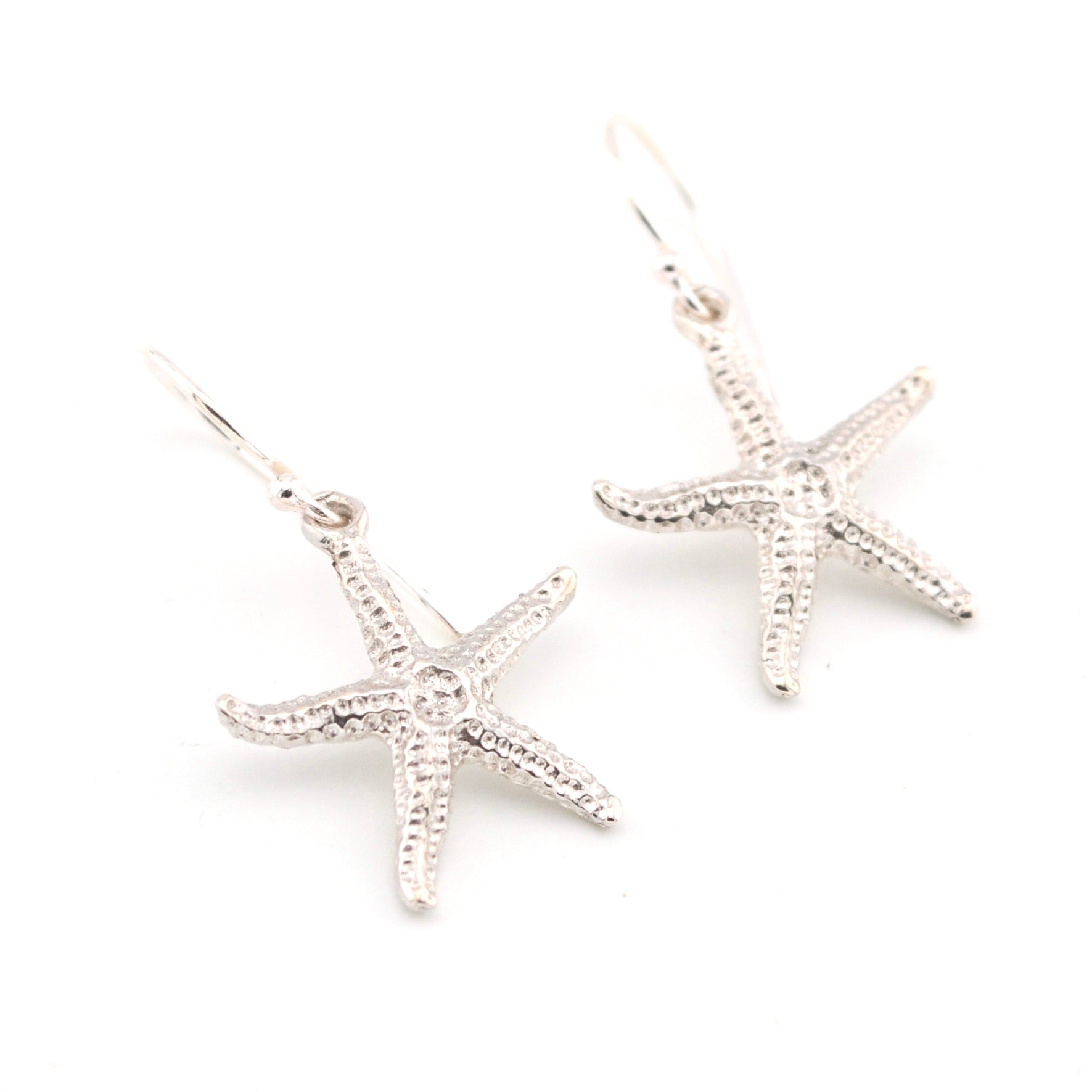 Starfish-shaped earrings on a white background