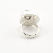 A polished silver-toned ring with a geometric, multi-faceted top and a smooth circular band, shown on a plain white background.