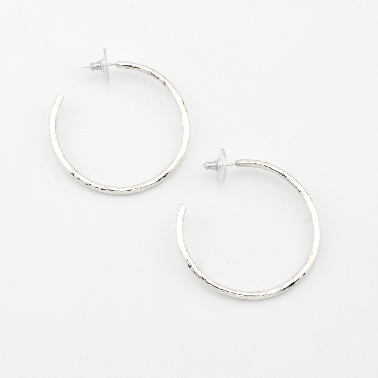 Silver hoop earrings on a white background