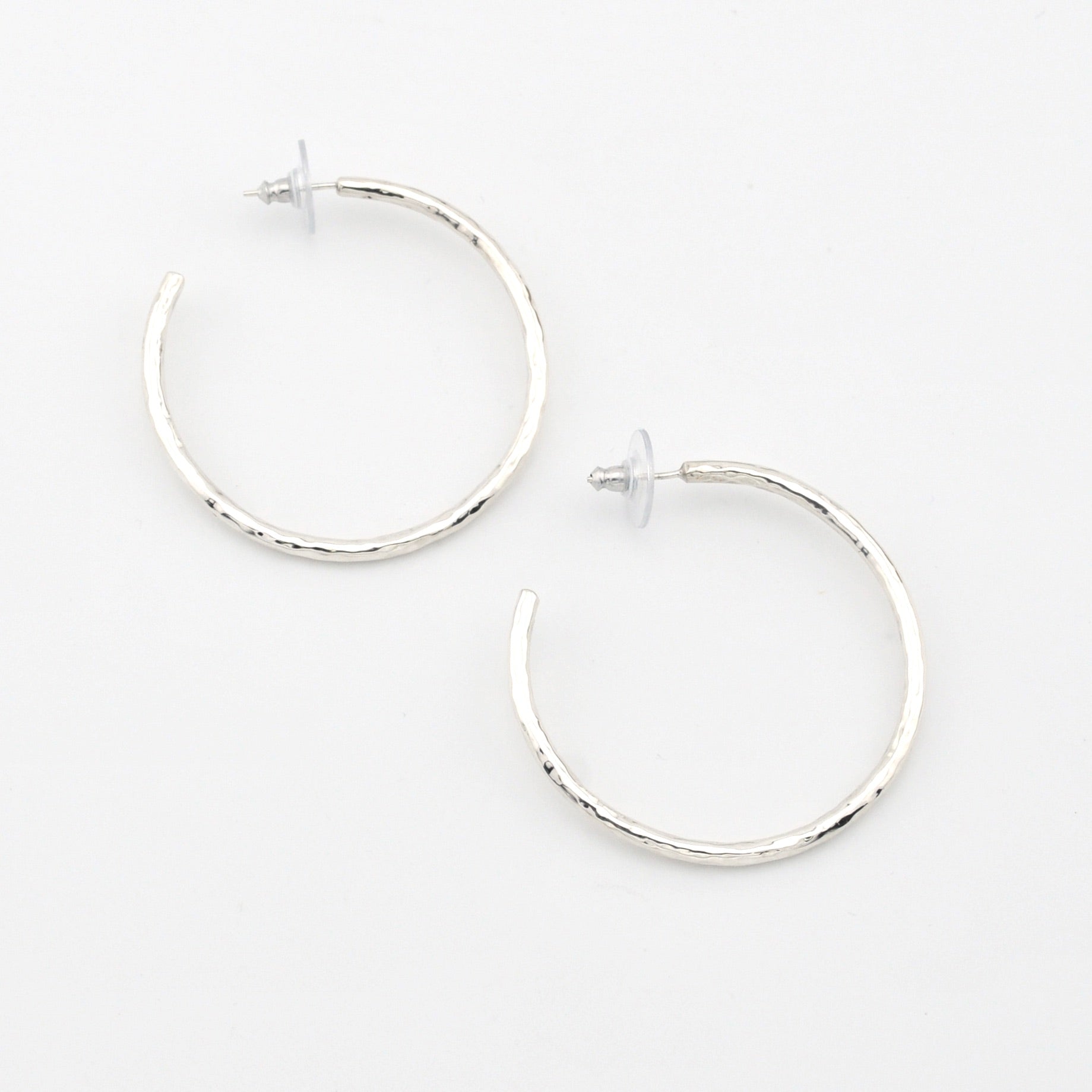 Silver hoop earrings on a white background