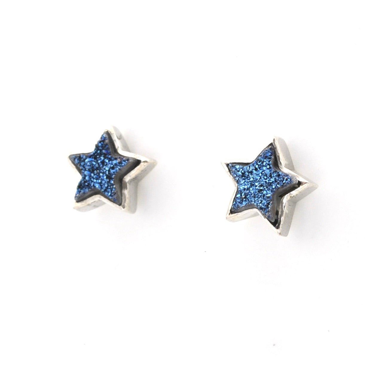 A pair of round amber stud earrings with silver posts, shown on a clean white background.