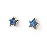A pair of round amber stud earrings with silver posts, shown on a clean white background.