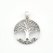 A silver tree of life pendant with intricate filigree cutouts and a heart-shaped base, shown on a plain white background.