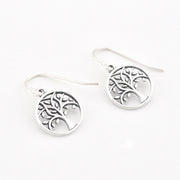 A pair of silver tree of life drop earrings with fishhook wires, displayed on a clean white background.