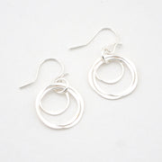 Pair of silver hoop earrings on a white background