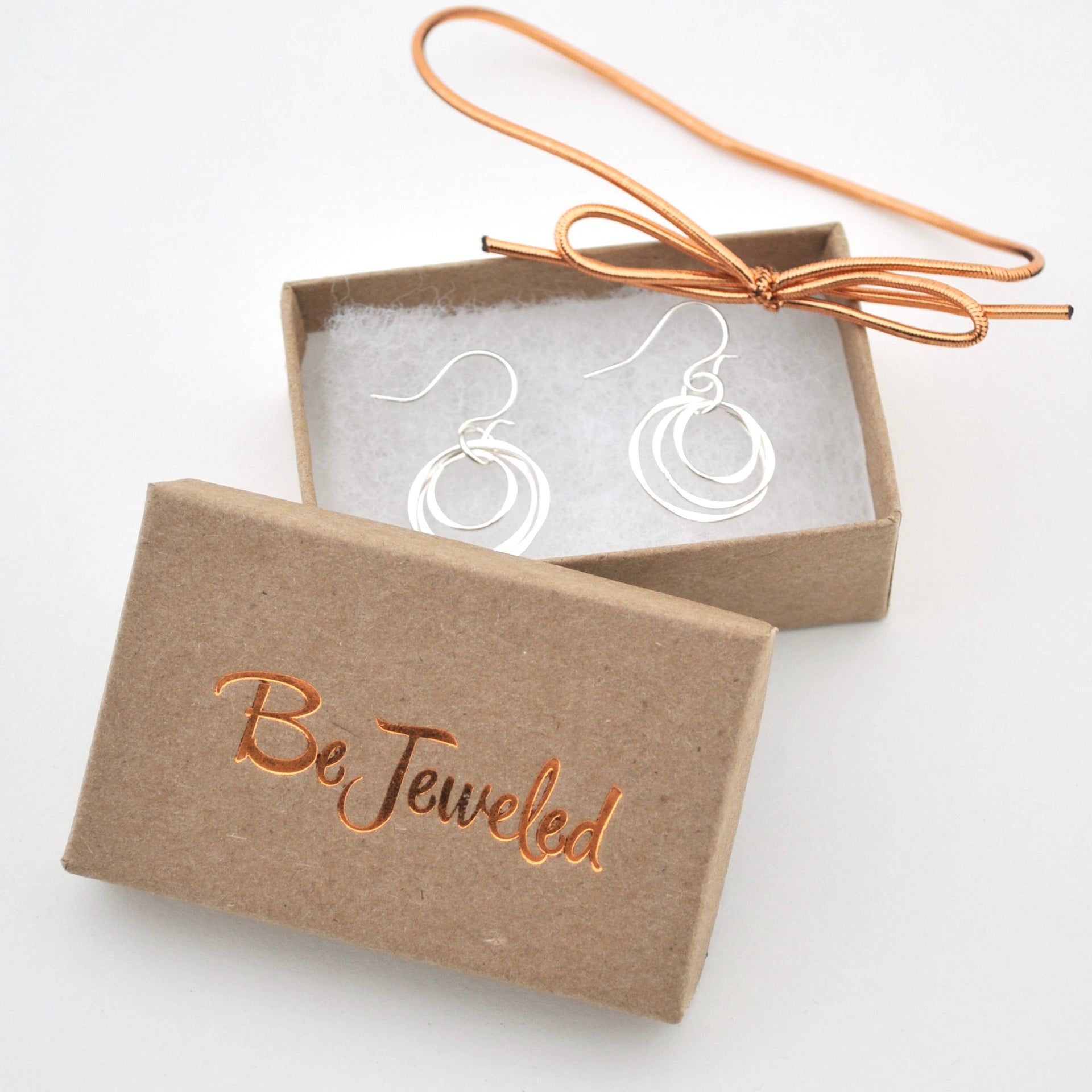 Silver earrings in a 'Be Jeweled' box on a white background