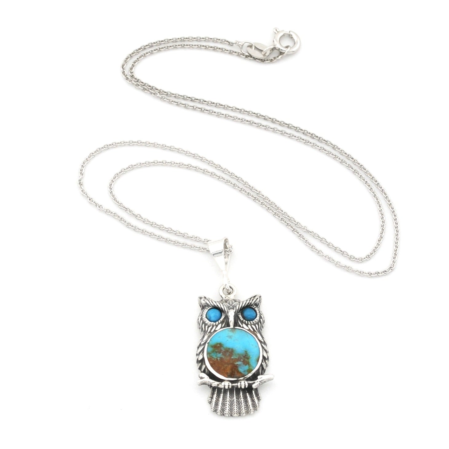 A sterling silver owl pendant necklace featuring a turquoise and brown stone face with blue stone eyes, displayed on a clean white background.