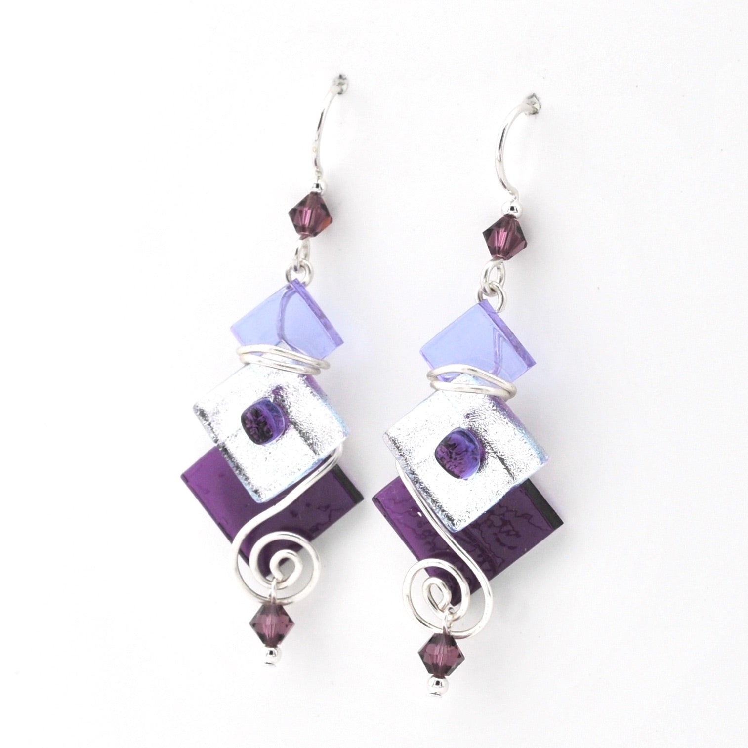 Pair of earrings with purple and silver design on a white background