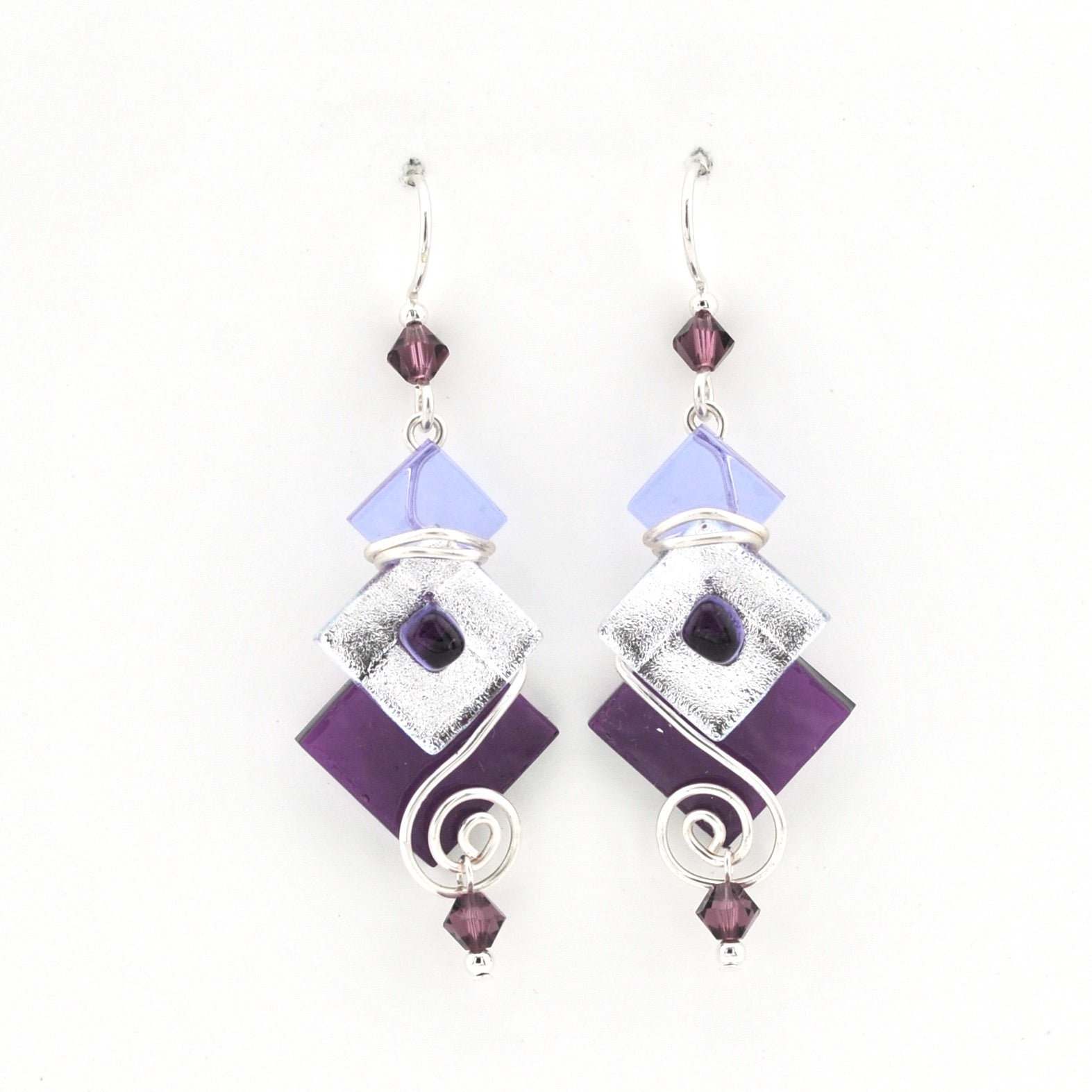 Pair of earrings with purple and silver design on a white background