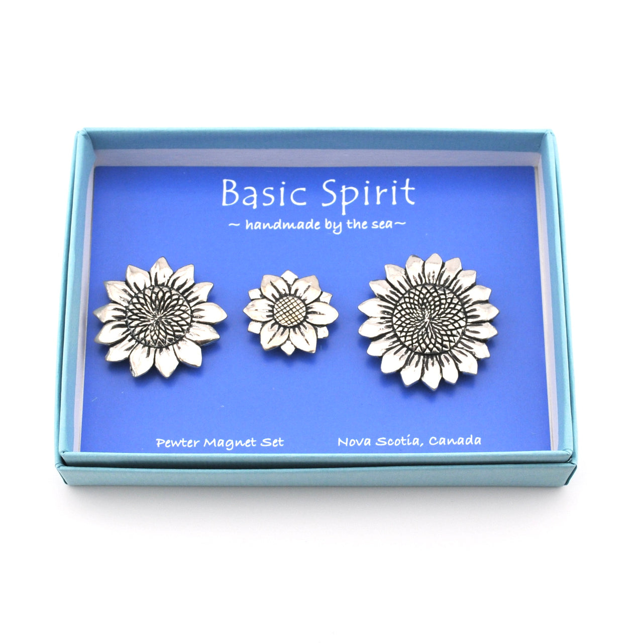 Set of three silver sunflower-shaped magnets in a 'Basic Spirit' branded box.