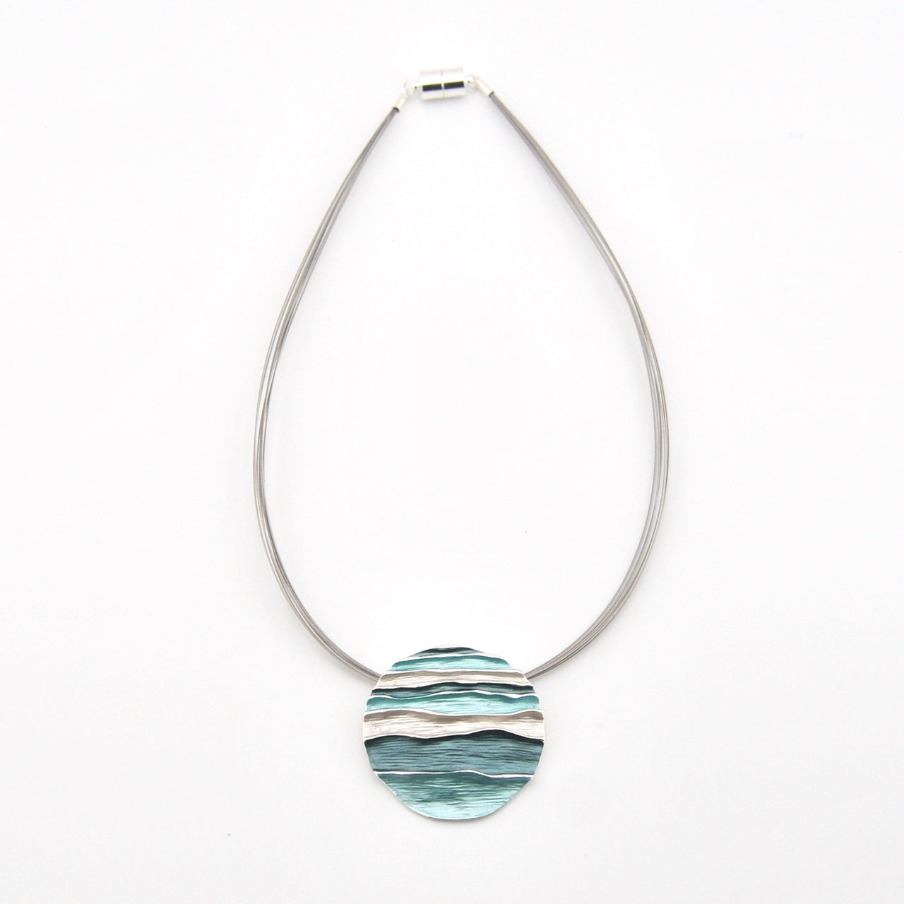 Necklace with a round, marbled pendant on a white background