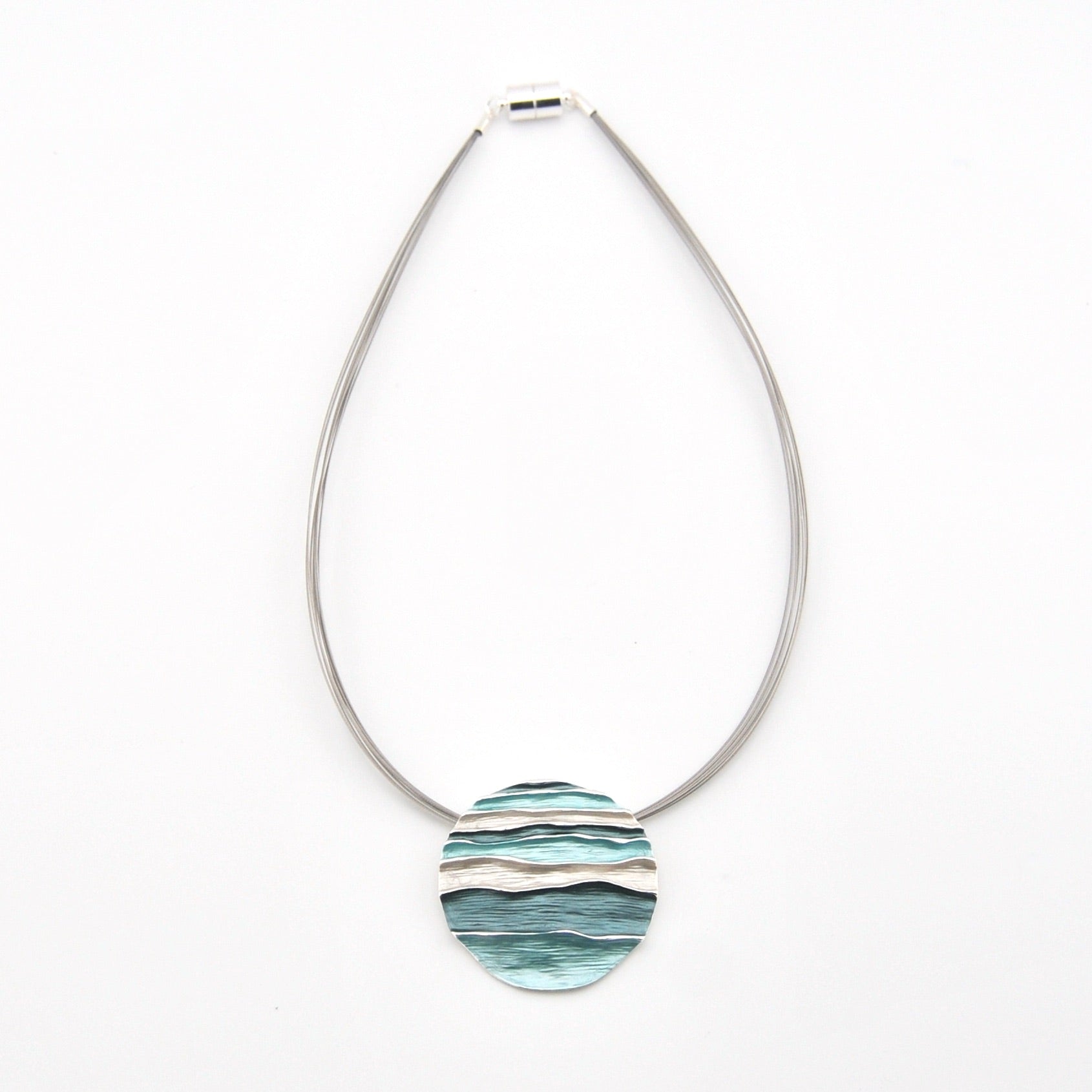 Necklace with a round, marbled pendant on a white background