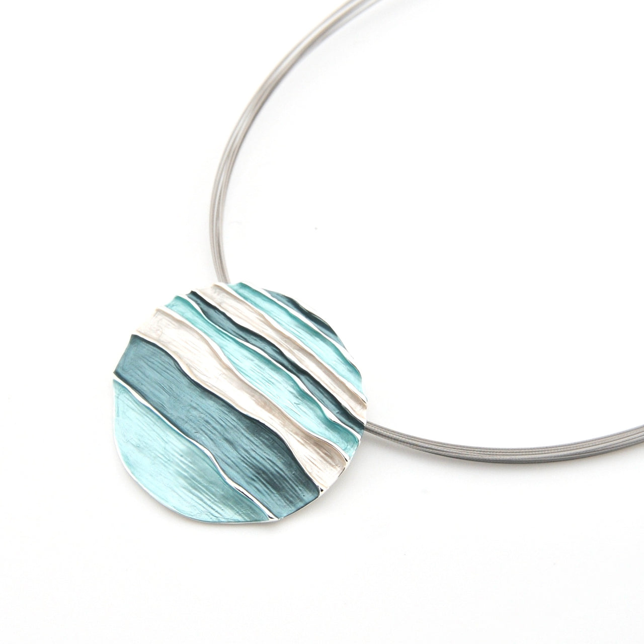 Necklace with a blue and silver pendant on a white background