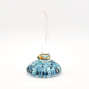 Glass ornament with blue pattern on a white background
