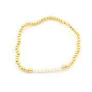 A delicate beaded bracelet featuring small metallic gold beads and a row of white freshwater pearls on one side, displayed on a clean white background.