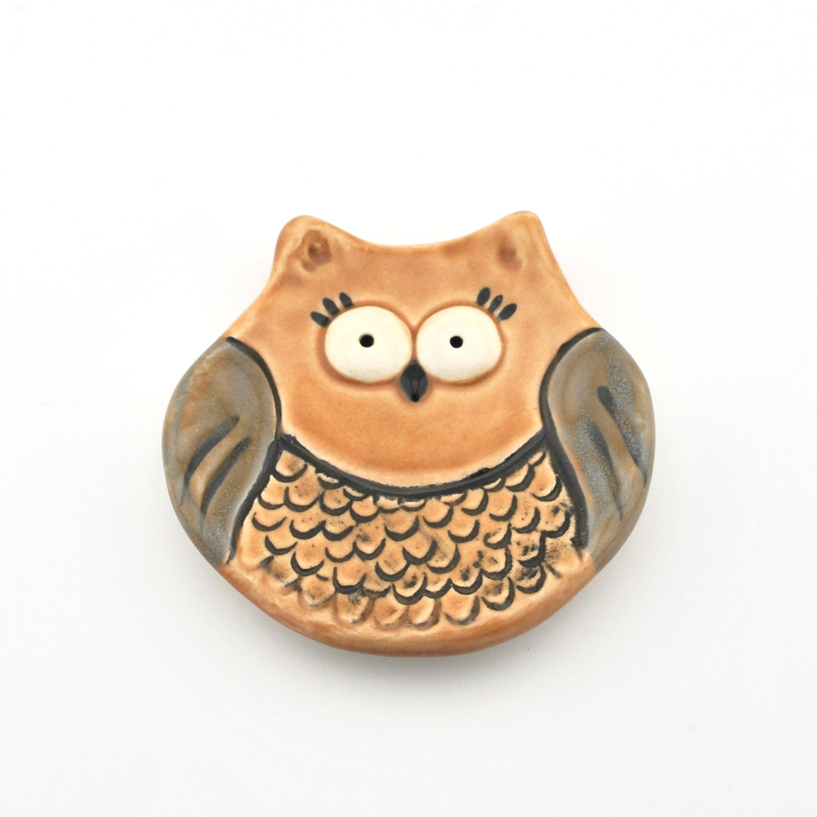 Ceramic owl-shaped dish on a white background