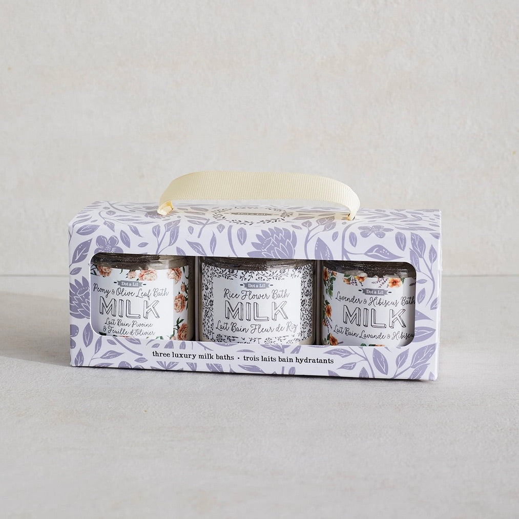 Three milk products in a decorative box on a light gray background