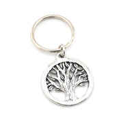 Silver keychain with tree of life design on a white background