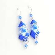 Blue glass earrings with silver accents on a white background