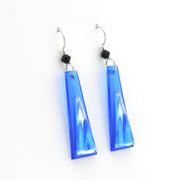 Blue glass earrings on white background.