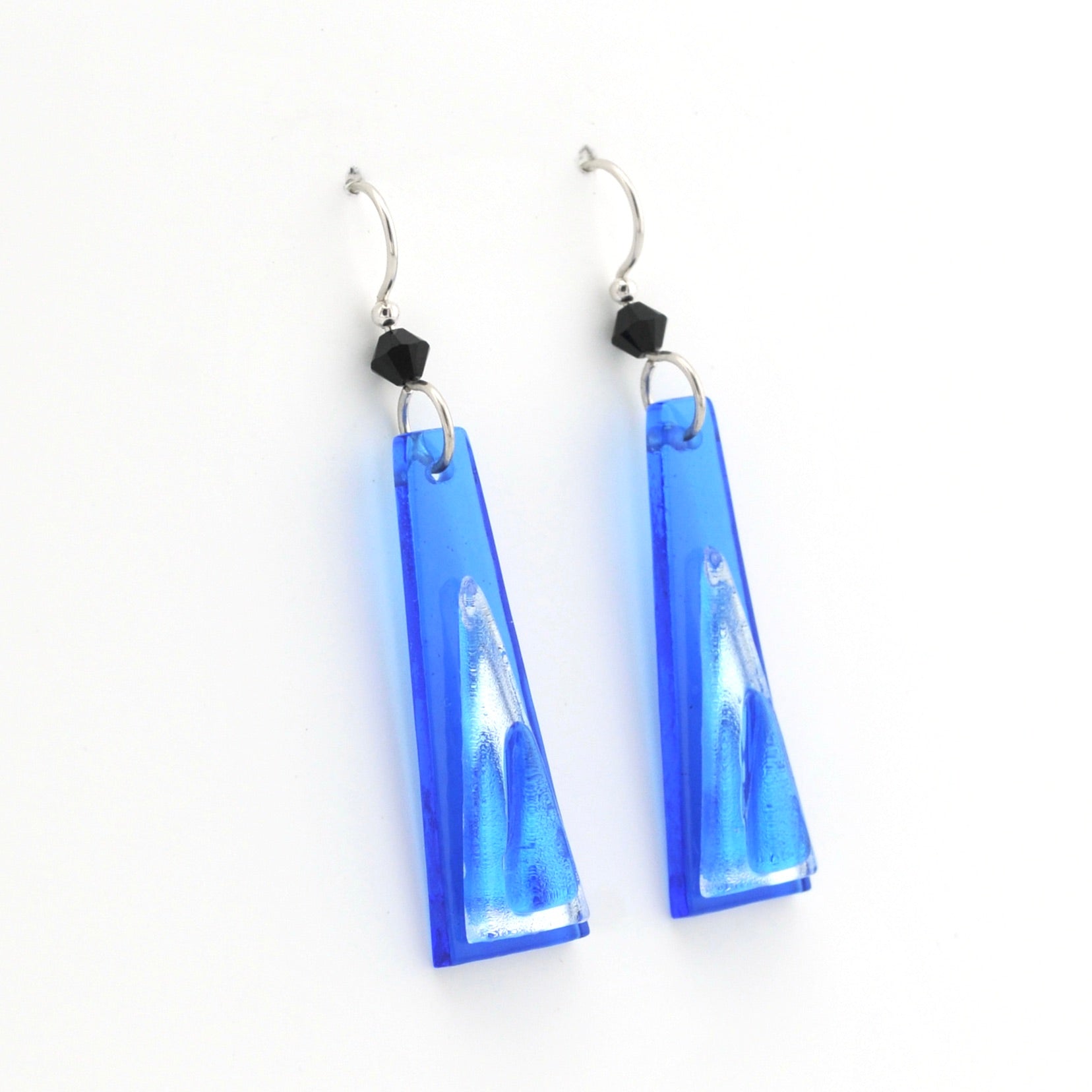 Blue glass earrings on white background.