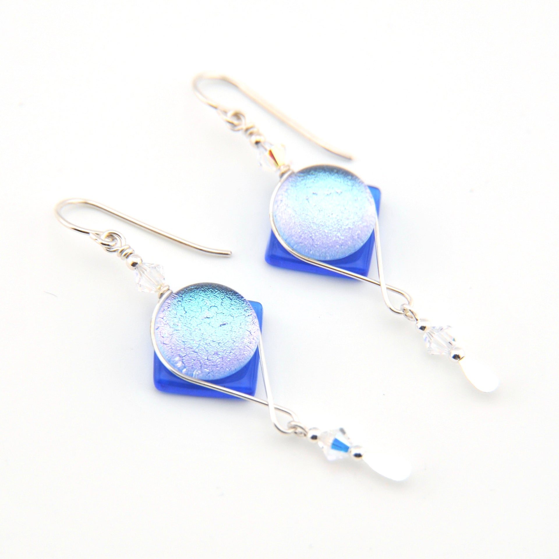 Pair of earrings with blue and white gradient stones on a white background