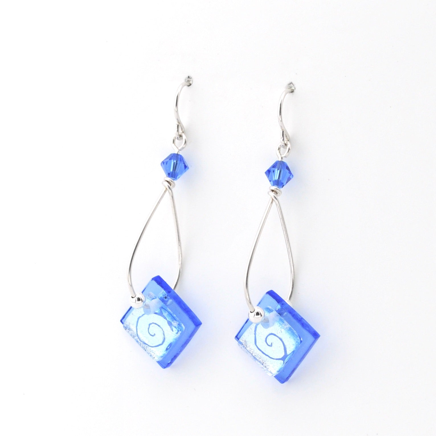 Blue square earrings with silver hooks on a white background