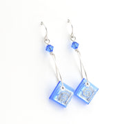 Pair of blue square earrings with silver hooks on a white background