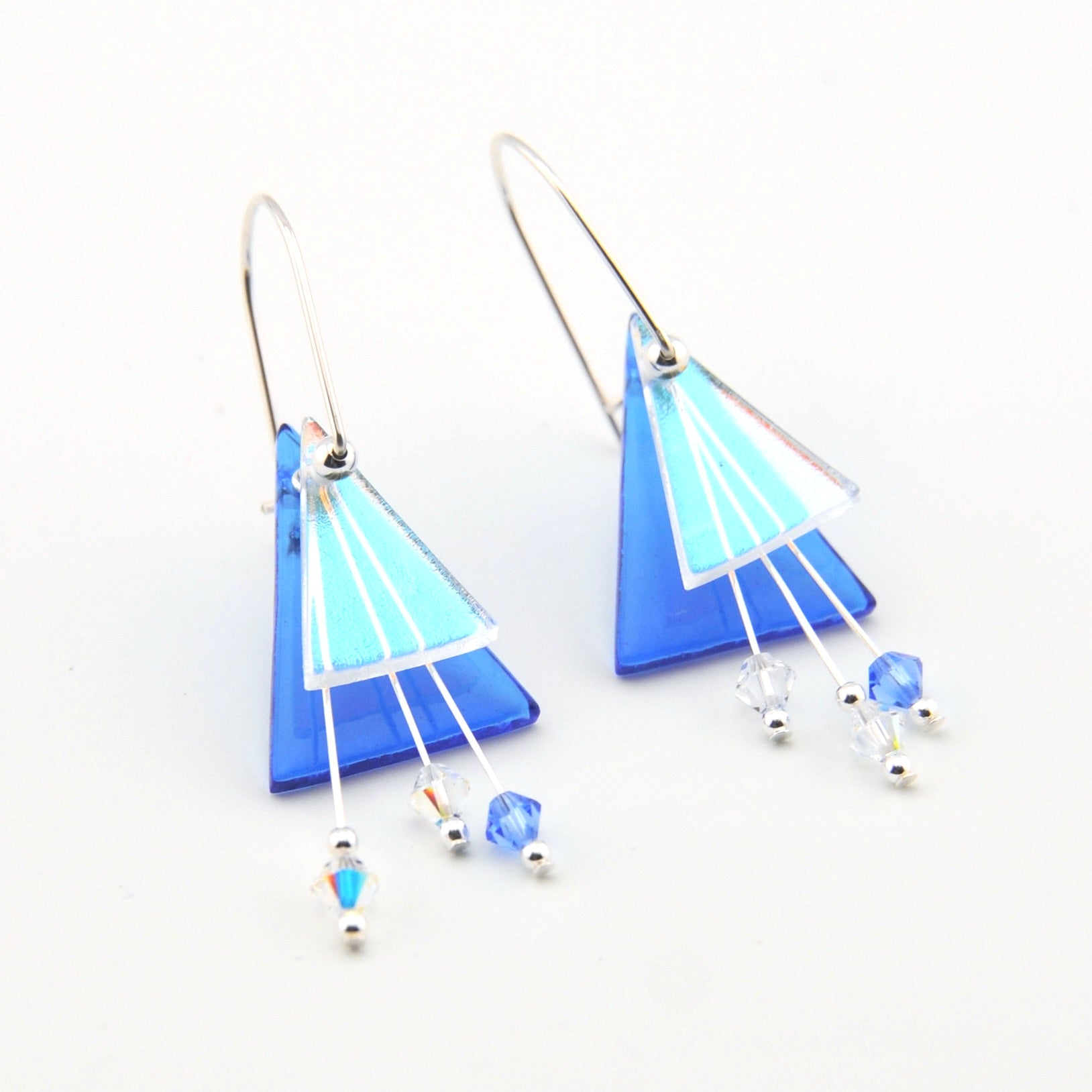 Blue and white geometric earrings on a white background