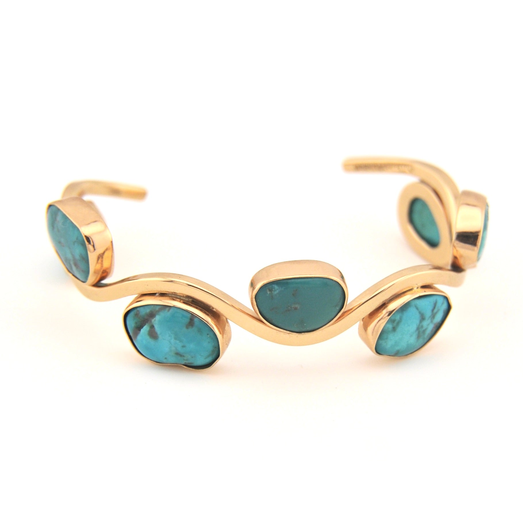 Gold bracelet with turquoise stones on a white background