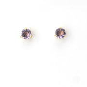 Pair of round purple gemstone earrings on a white background