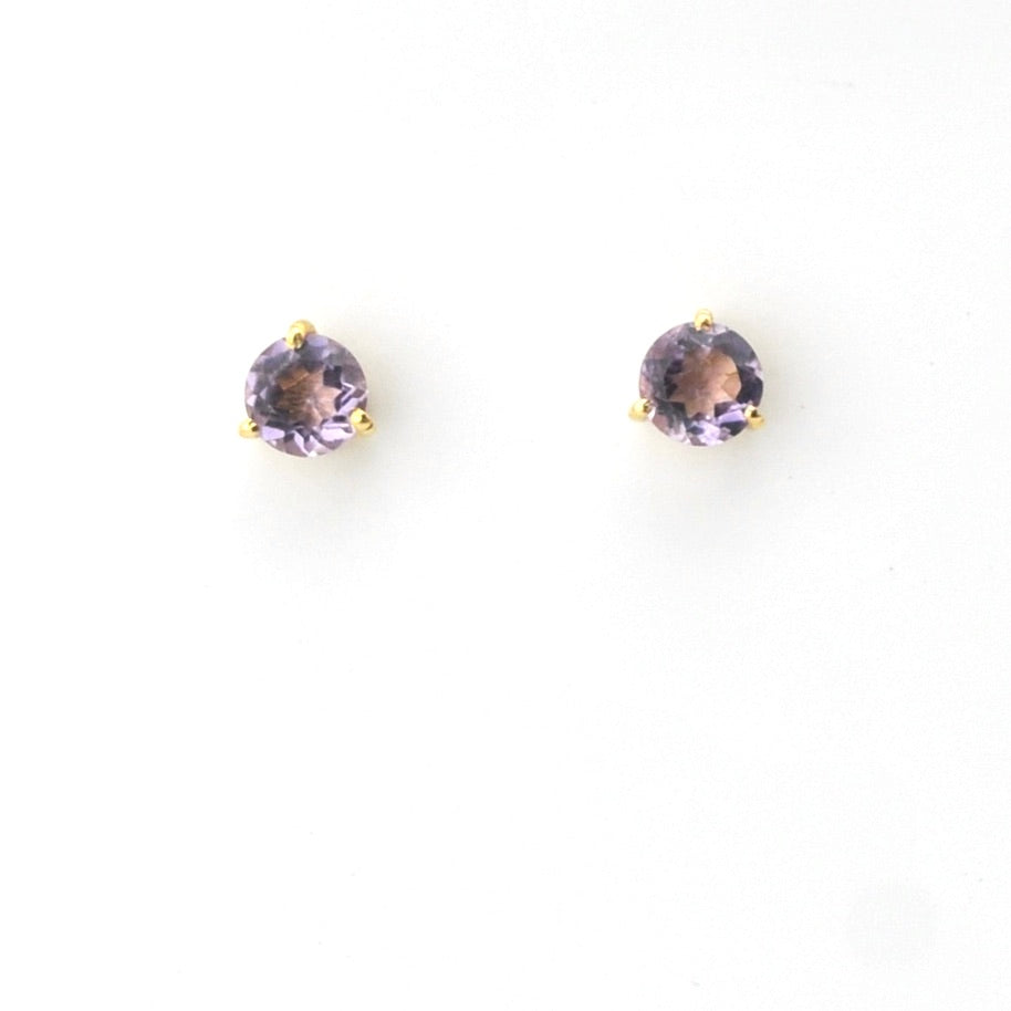 Pair of round purple gemstone earrings on a white background