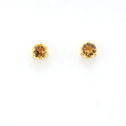 Pair of round gemstone stud earrings on a white background
