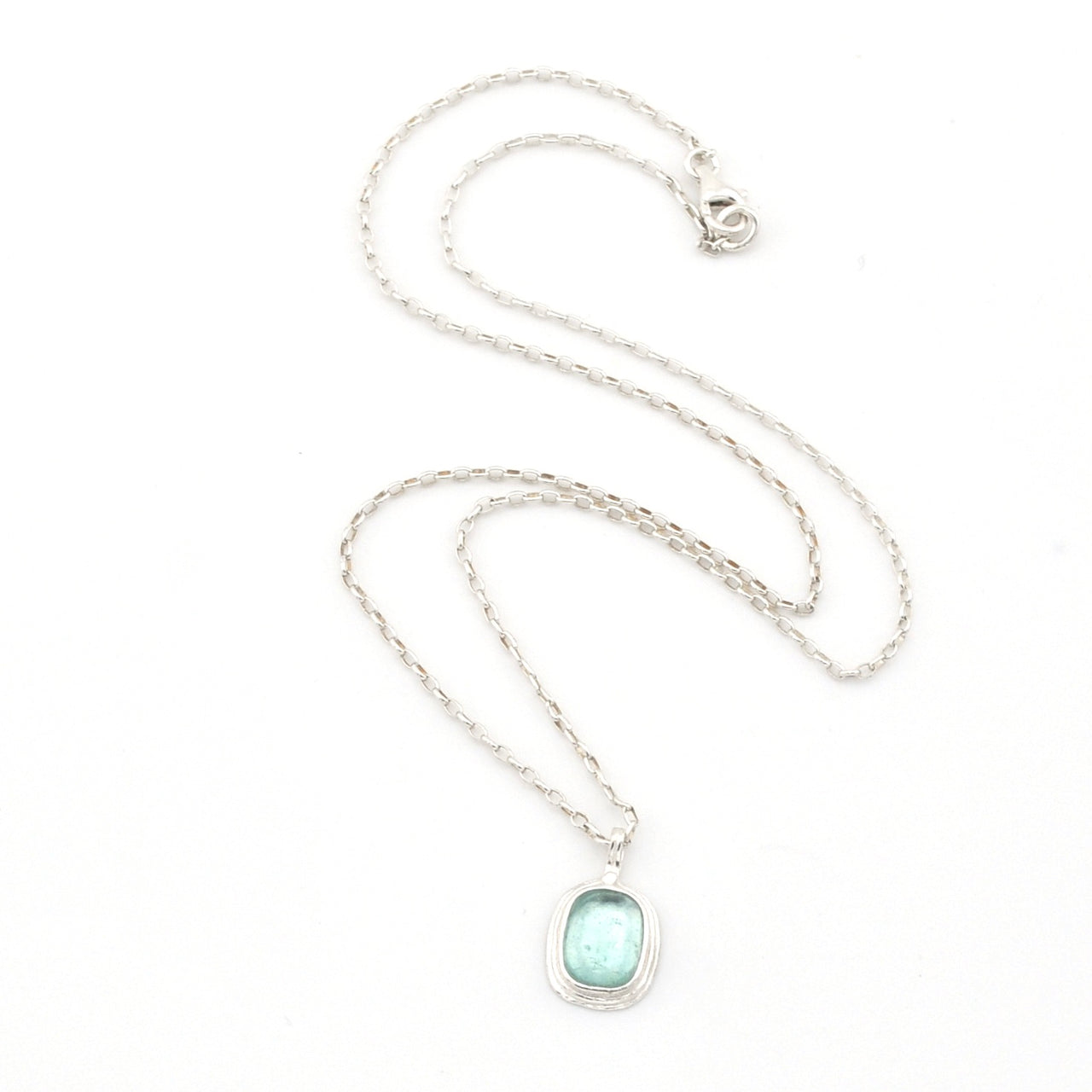 Necklace with a light blue pendant on a white background