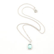Necklace with a light blue pendant on a white background