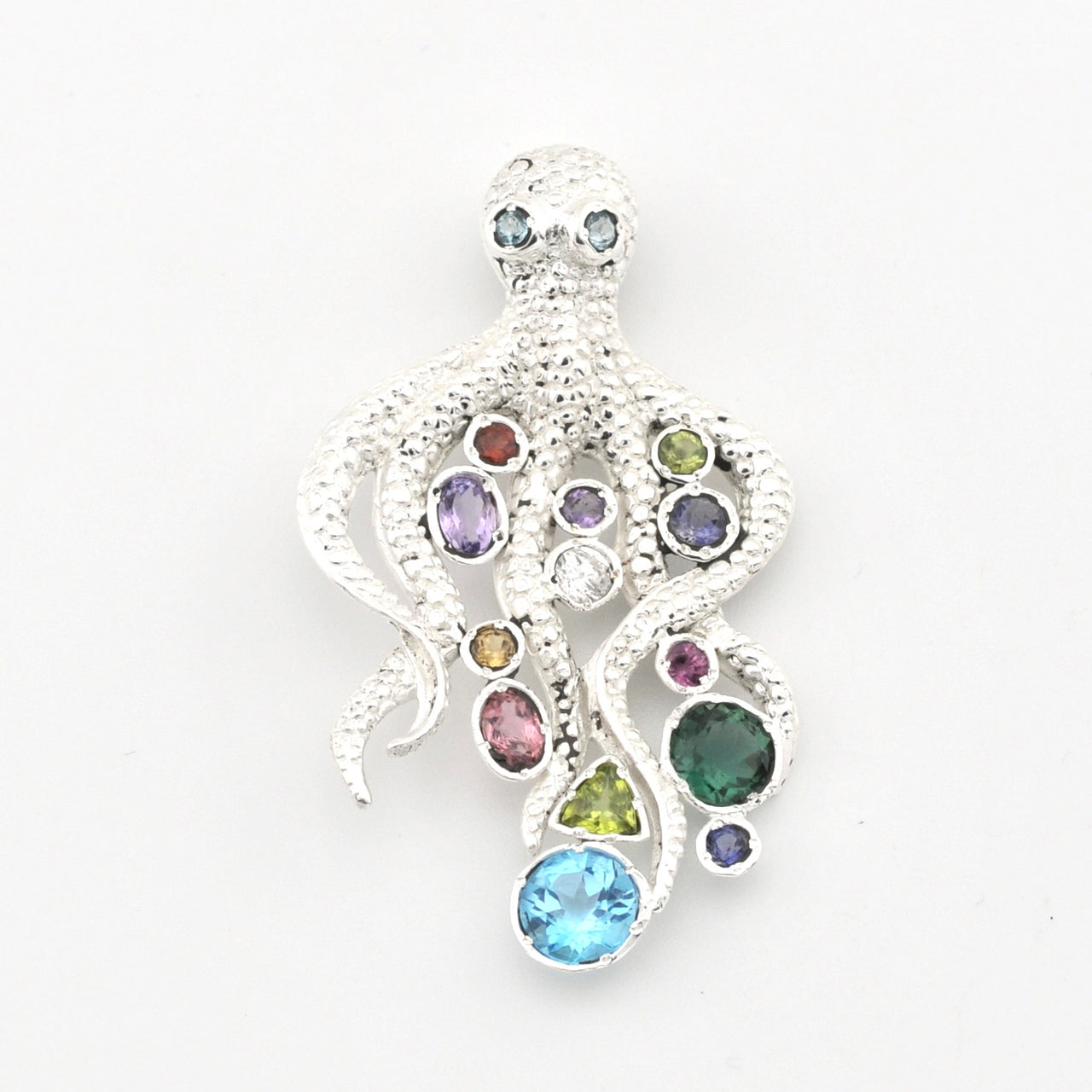 A silver octopus-shaped pendant featuring multiple colorful gemstones in various shapes and sizes, set against a plain white background.