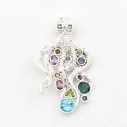 A silver octopus-shaped pendant featuring multiple colorful gemstones in various shapes and sizes, set against a plain white background.