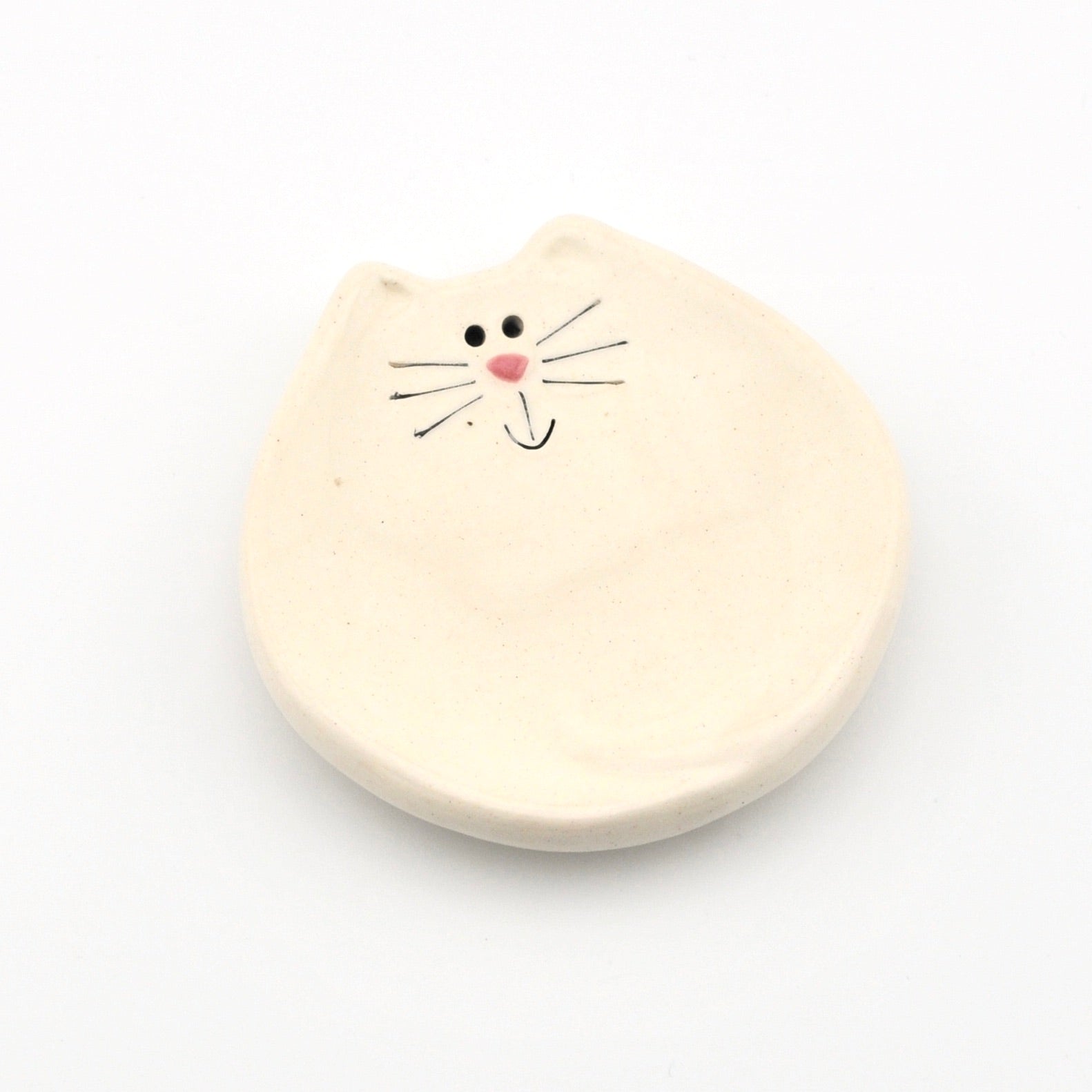 Dish with a cat face on a white background