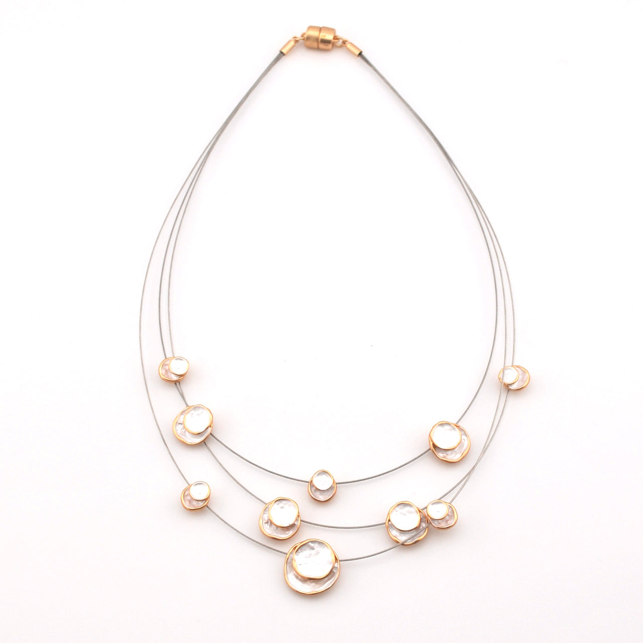 Necklace with multiple pearl-like beads on a white background