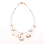 Necklace with multiple pearl-like beads on a white background